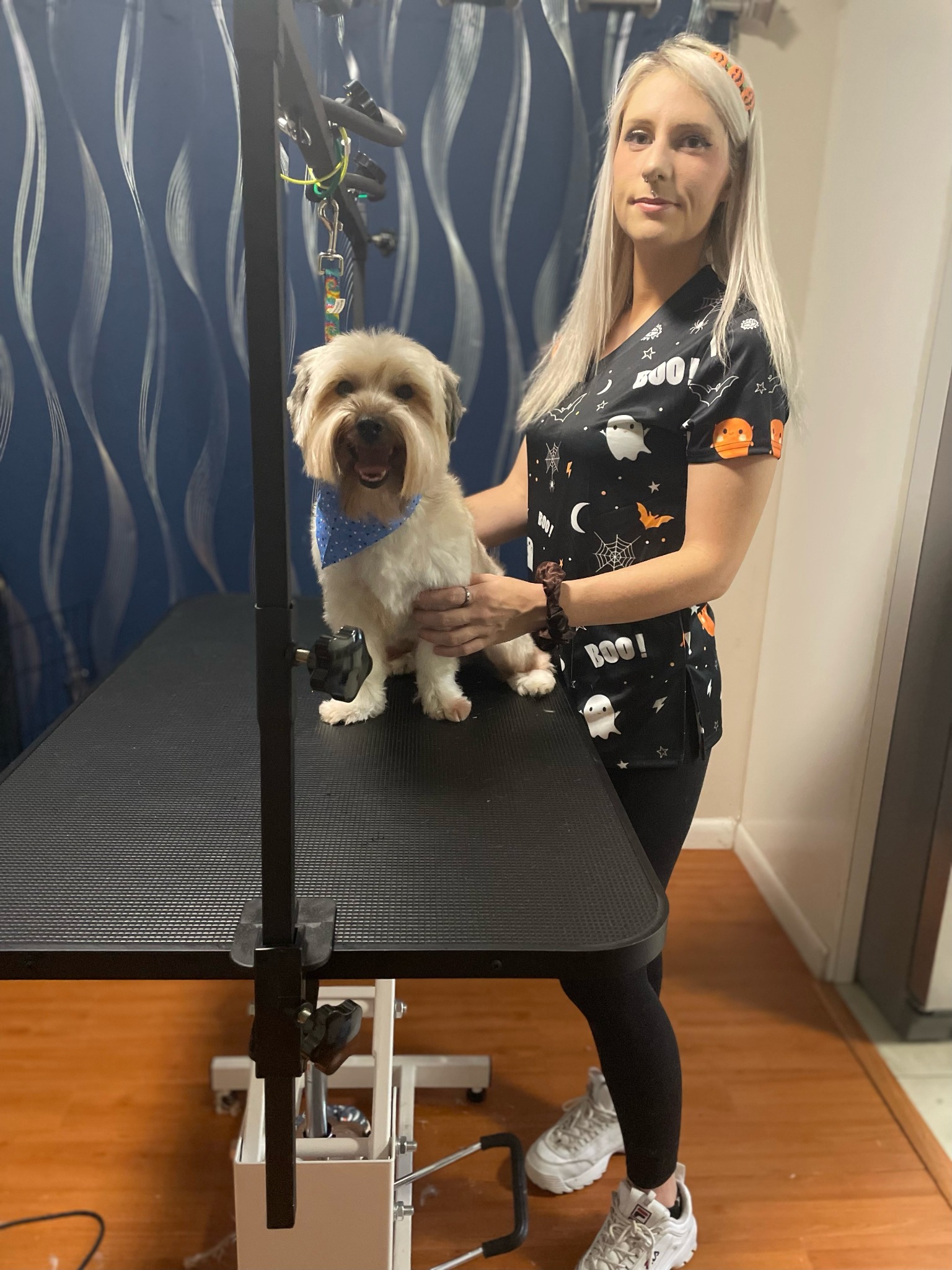 Brooke with a freshly groomed dog at her grooming table